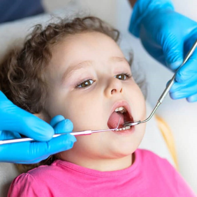 examination-treatment-teeth-children-medical-checkup-oral-cavity-with-instruments-dental-hands-child-in-office-cute-girl-smiling-stomatology-kid-in-dentist-chair-1024x683.jpg